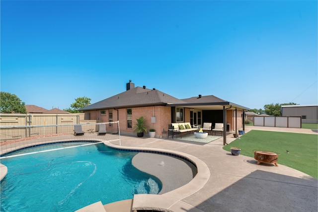 view of swimming pool with a patio area, outdoor lounge area, and a lawn