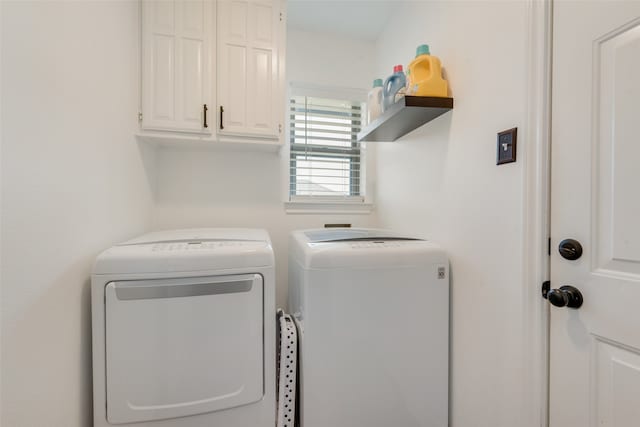 laundry area featuring cabinets and washer and clothes dryer