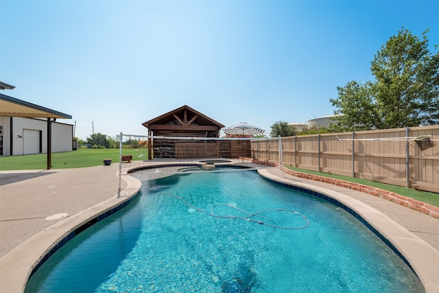 view of pool with a patio area and a yard