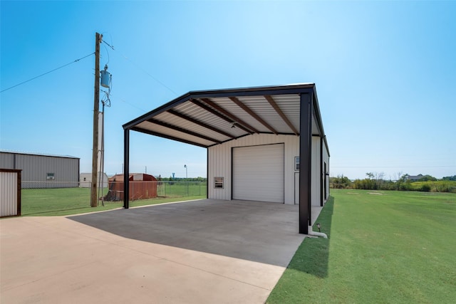 exterior space featuring driveway, a detached garage, and fence