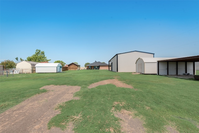 view of yard featuring a garage and an outbuilding