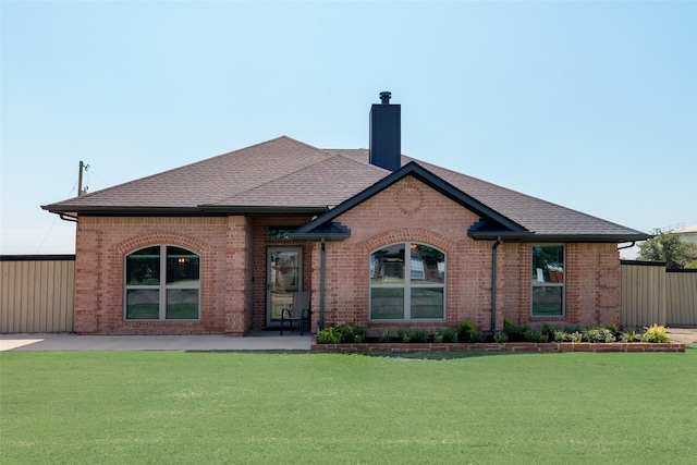 back of house with a yard