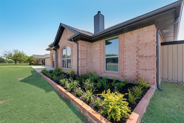 view of side of property with a lawn