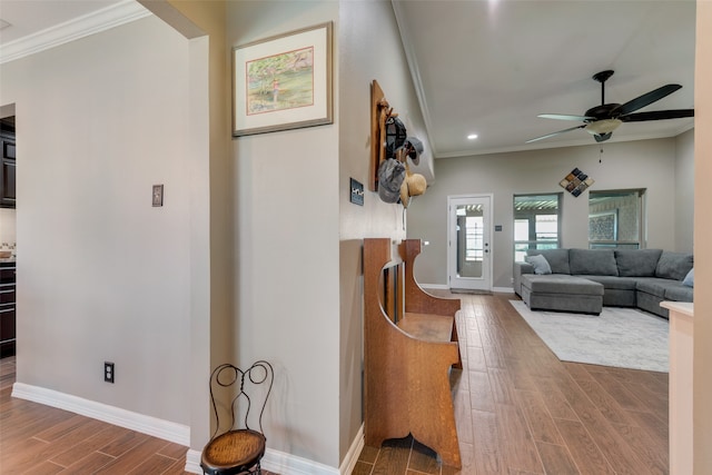 living room with ceiling fan, crown molding, and hardwood / wood-style flooring