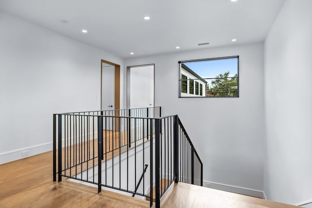 staircase with wood-type flooring