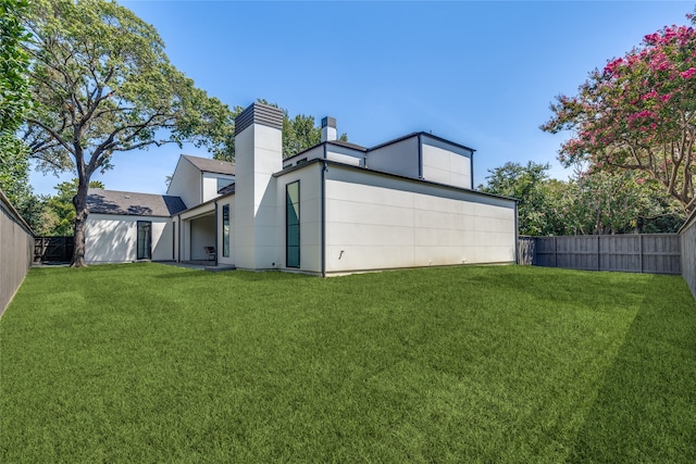 view of side of home with a yard