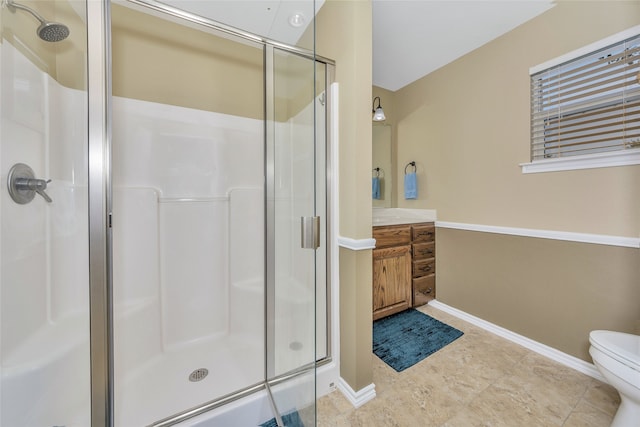 bathroom with tile patterned flooring, vanity, walk in shower, and toilet