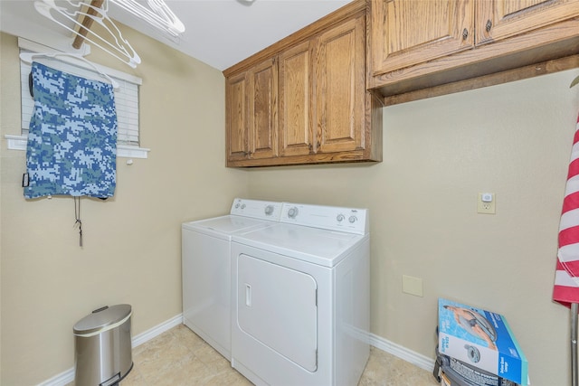 laundry area with separate washer and dryer, light tile patterned flooring, and cabinets