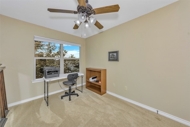 home office with ceiling fan and light carpet