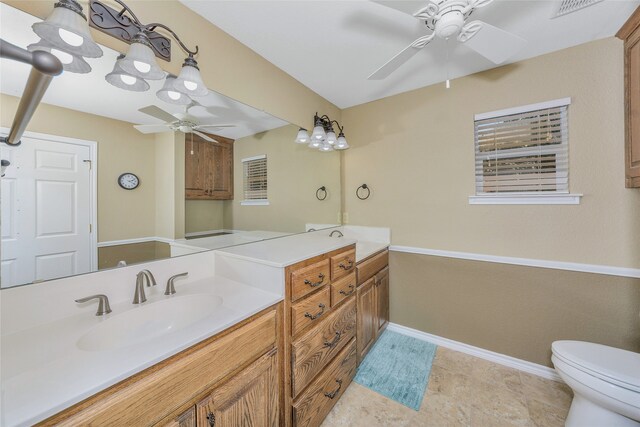 bathroom featuring ceiling fan, toilet, vanity, and tile patterned floors