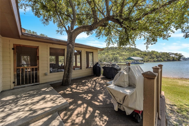 wooden terrace featuring a water view