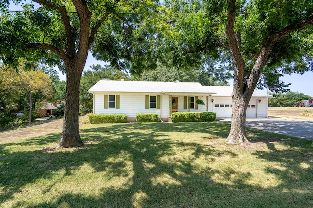 ranch-style house featuring a garage and a front yard