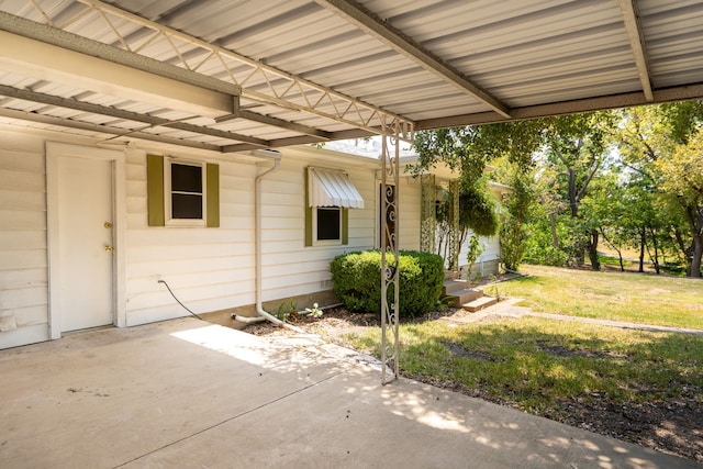view of side of property with a patio and a yard