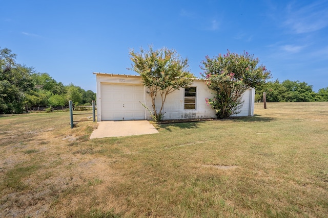 view of front of property with a front lawn and a garage