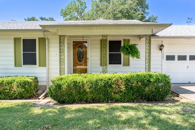 view of front of property with a garage and a front lawn