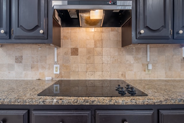 kitchen with black electric cooktop, tasteful backsplash, and wall chimney range hood