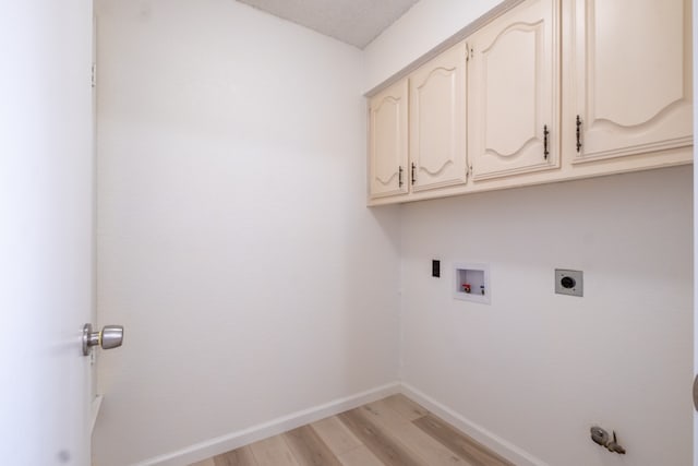 laundry room featuring hookup for an electric dryer, light wood-type flooring, cabinets, and washer hookup