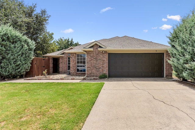 single story home featuring a garage and a front yard