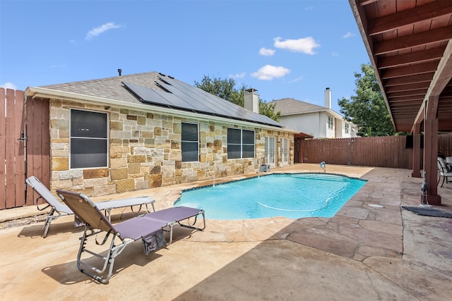 view of pool with pool water feature and a patio area