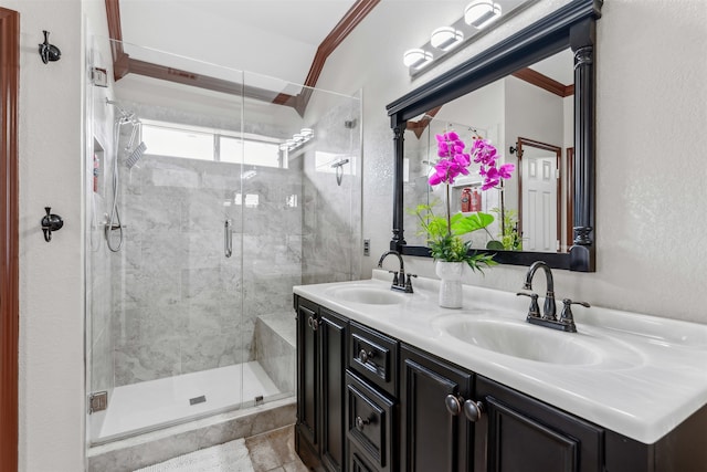 bathroom featuring tile patterned flooring, ornamental molding, vanity, and walk in shower