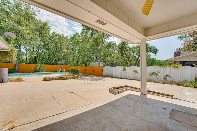 view of patio / terrace with ceiling fan and a fenced in pool