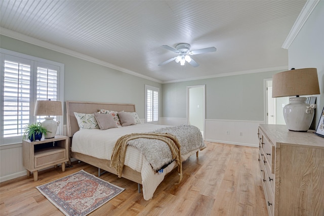 bedroom with ceiling fan, ornamental molding, and light hardwood / wood-style flooring