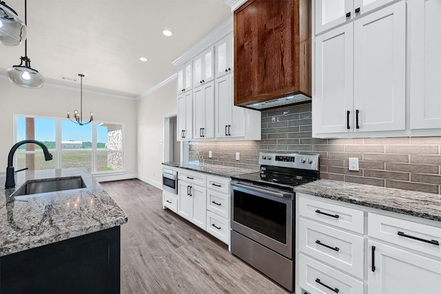 kitchen featuring backsplash, appliances with stainless steel finishes, light hardwood / wood-style floors, crown molding, and white cabinets