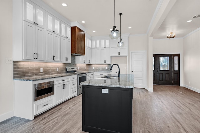 kitchen featuring light hardwood / wood-style floors, stainless steel range with electric stovetop, ornamental molding, sink, and white cabinets