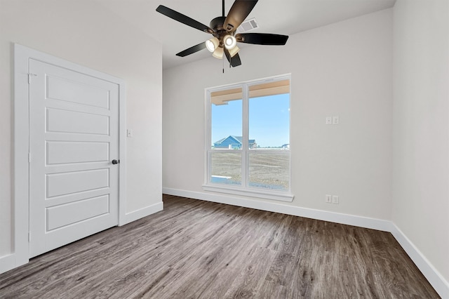 empty room with ceiling fan and hardwood / wood-style flooring