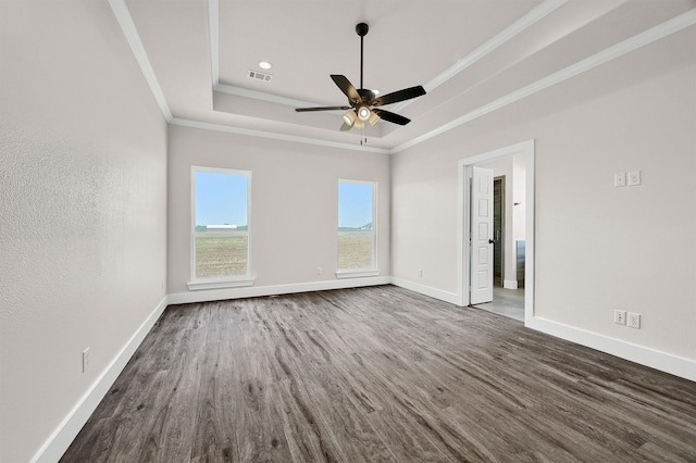 unfurnished room with hardwood / wood-style floors, a raised ceiling, crown molding, and ceiling fan