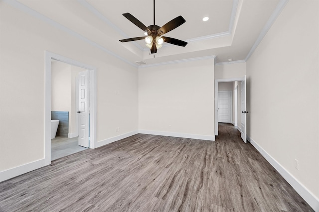 spare room featuring ceiling fan, a raised ceiling, crown molding, and hardwood / wood-style flooring