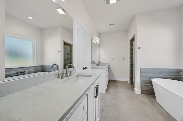 bathroom featuring plus walk in shower, hardwood / wood-style flooring, and vanity