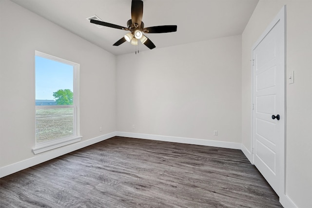 unfurnished room featuring ceiling fan and dark wood-type flooring