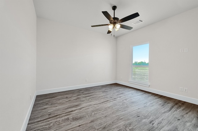 spare room with ceiling fan and wood-type flooring