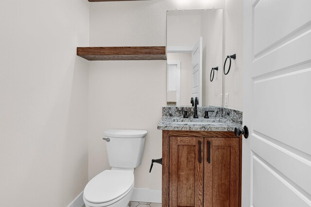 bathroom with tile patterned floors, toilet, and vanity