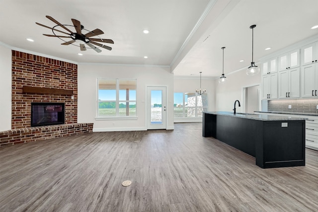 kitchen featuring white cabinets, light wood-type flooring, and tasteful backsplash