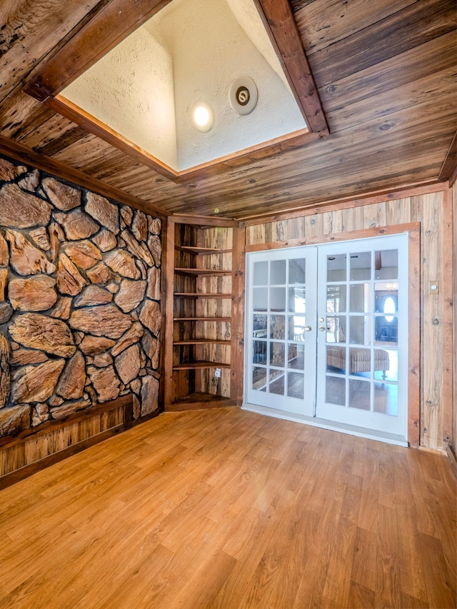 unfurnished room featuring french doors, light hardwood / wood-style flooring, wooden walls, and wood ceiling