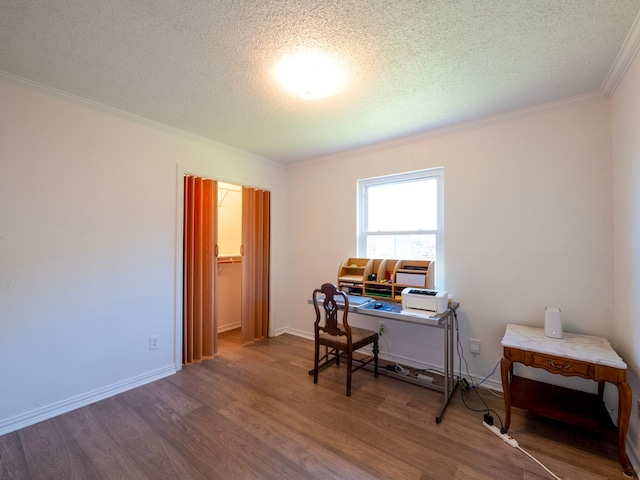 office area featuring hardwood / wood-style floors, crown molding, and a textured ceiling