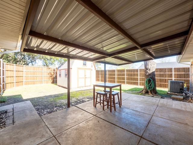 view of patio with a storage unit and cooling unit