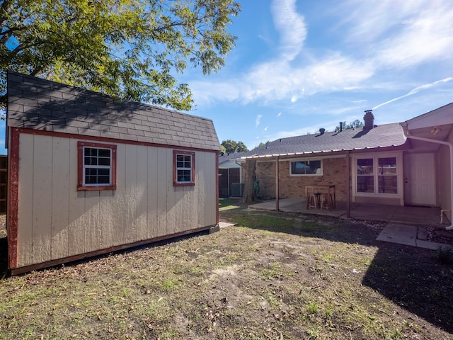 view of yard with a storage shed and a patio area