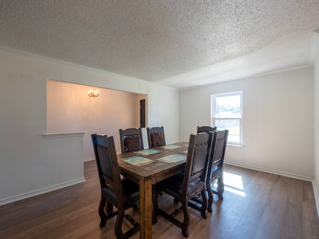 dining area with dark hardwood / wood-style floors, a textured ceiling, and ornamental molding