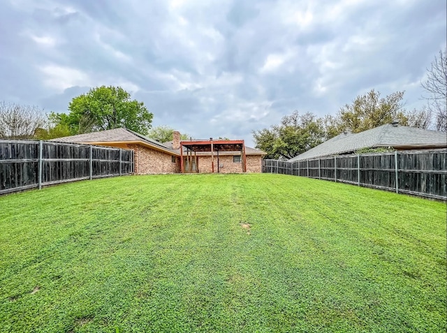 view of yard with a fenced backyard