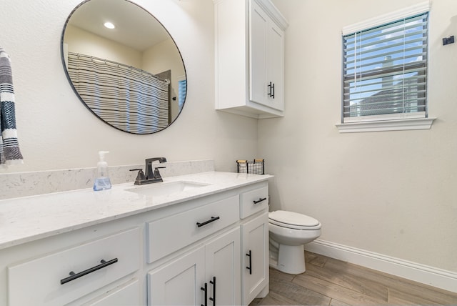 bathroom featuring hardwood / wood-style floors, vanity, and toilet