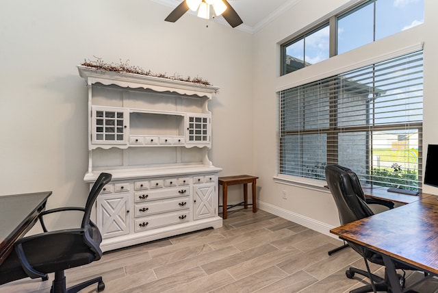 home office with ceiling fan, light wood-type flooring, crown molding, and a wealth of natural light