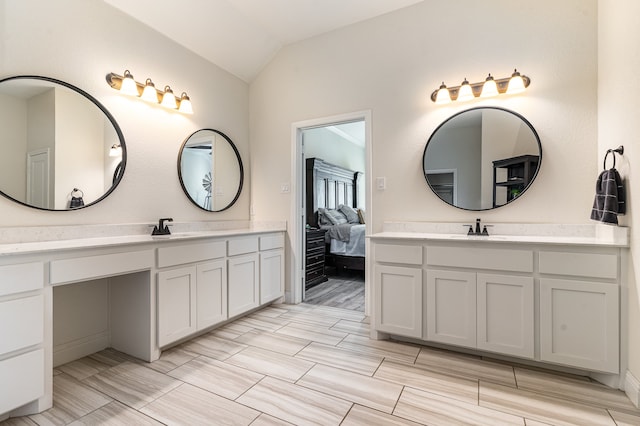 bathroom featuring vanity and lofted ceiling