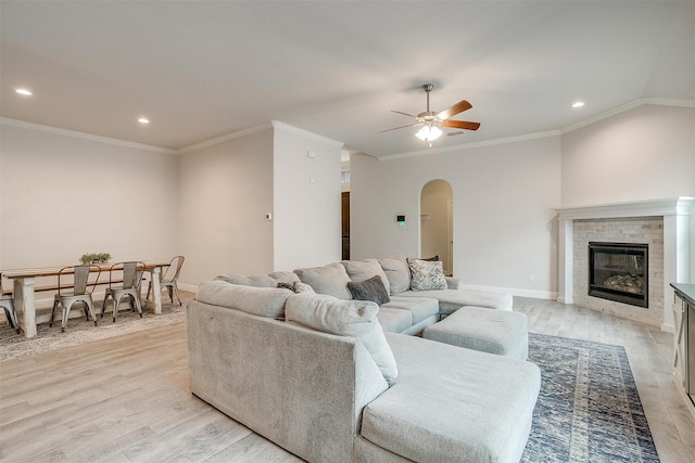 living room with crown molding and light wood-type flooring