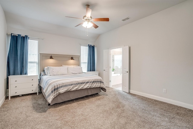 carpeted bedroom featuring vaulted ceiling, connected bathroom, and ceiling fan