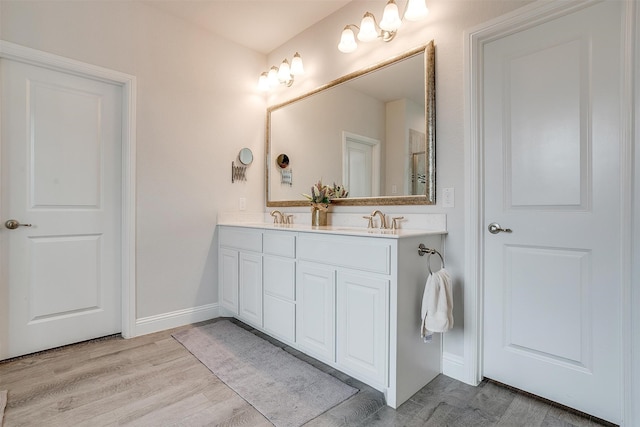 bathroom featuring vanity and wood-type flooring