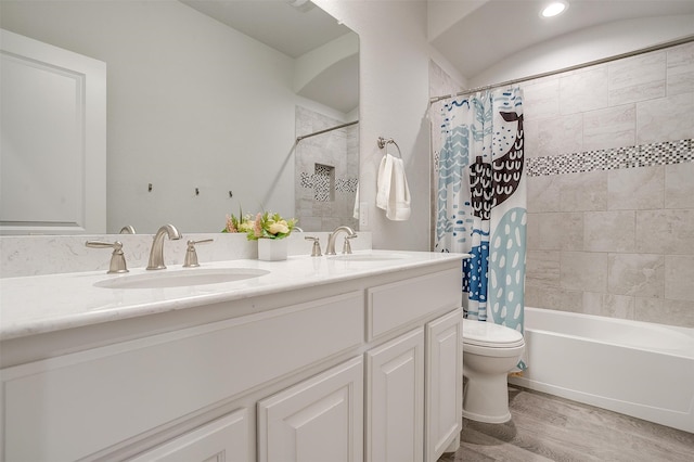 full bathroom with shower / bath combo, wood-type flooring, vanity, and toilet