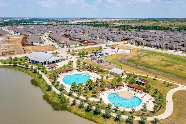 birds eye view of property with a water view